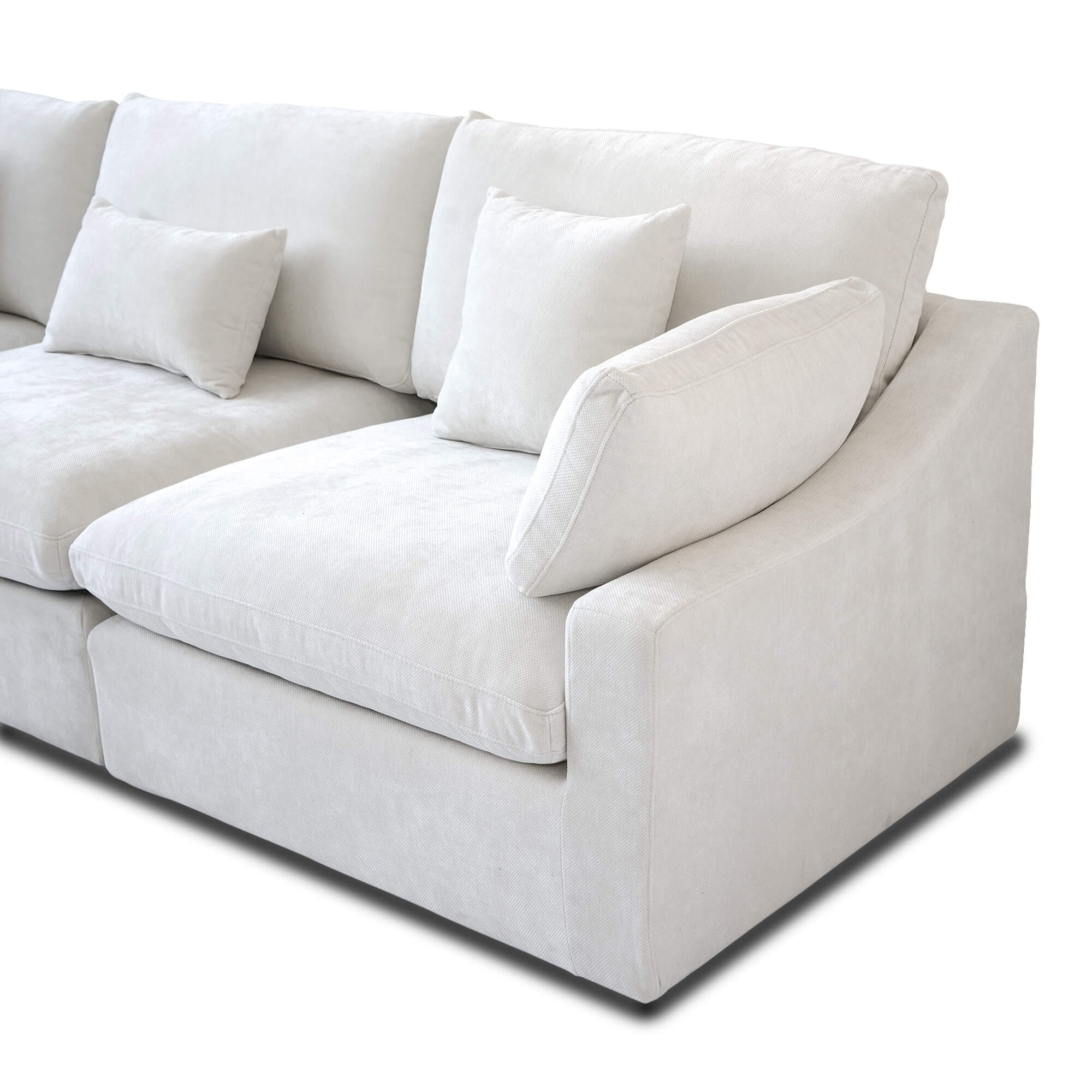 Close-up of a armrest seat of a white sofa with 2 accent pillows