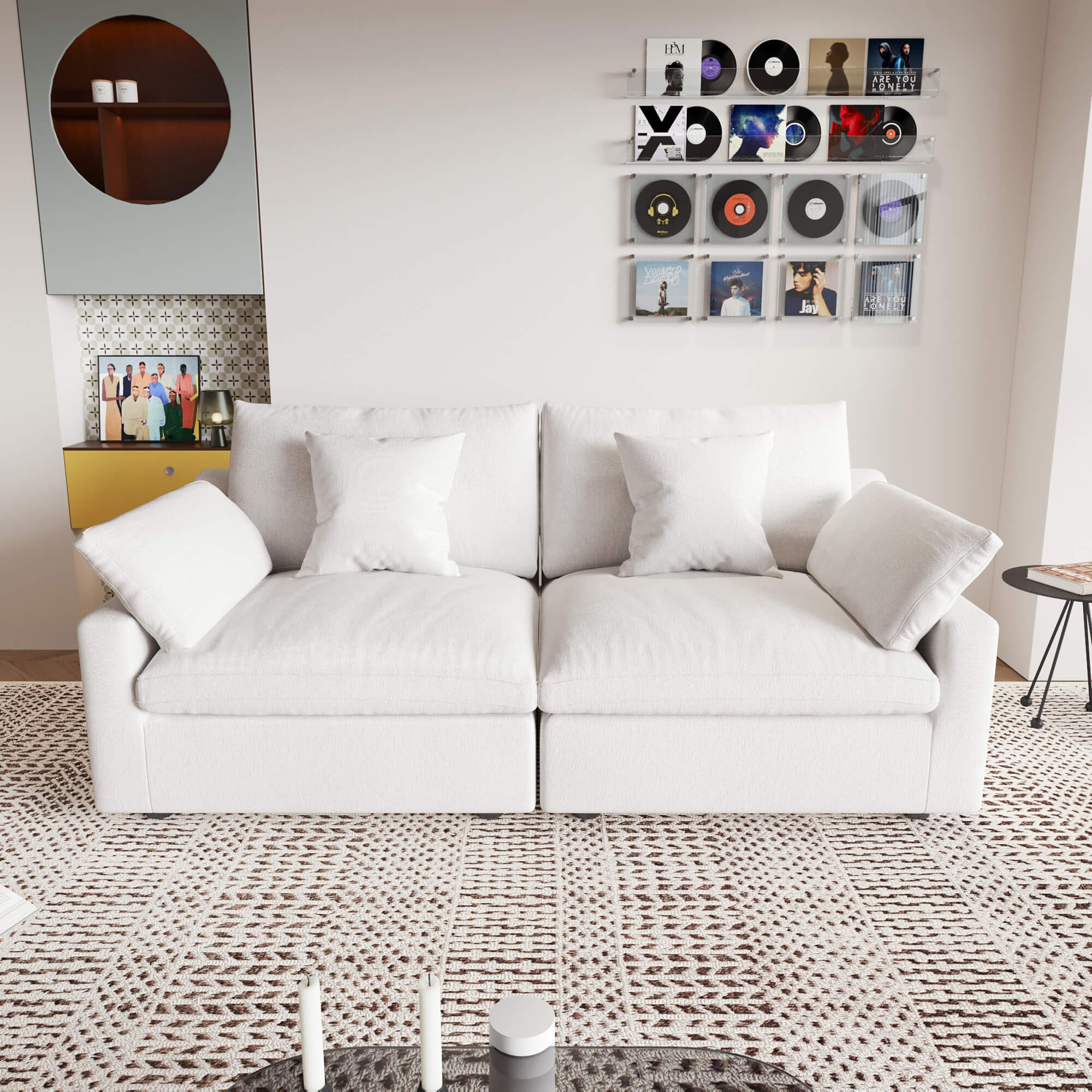 A white loveseat sofa, featuring a minimalist design with removable cushions, placed in a room with modern decor.