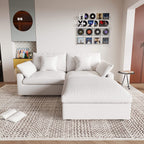 A white linen loveseat with ottoman, featuring a washable cloud design, placed on a patterned rug in a room with a record collection on the wall.