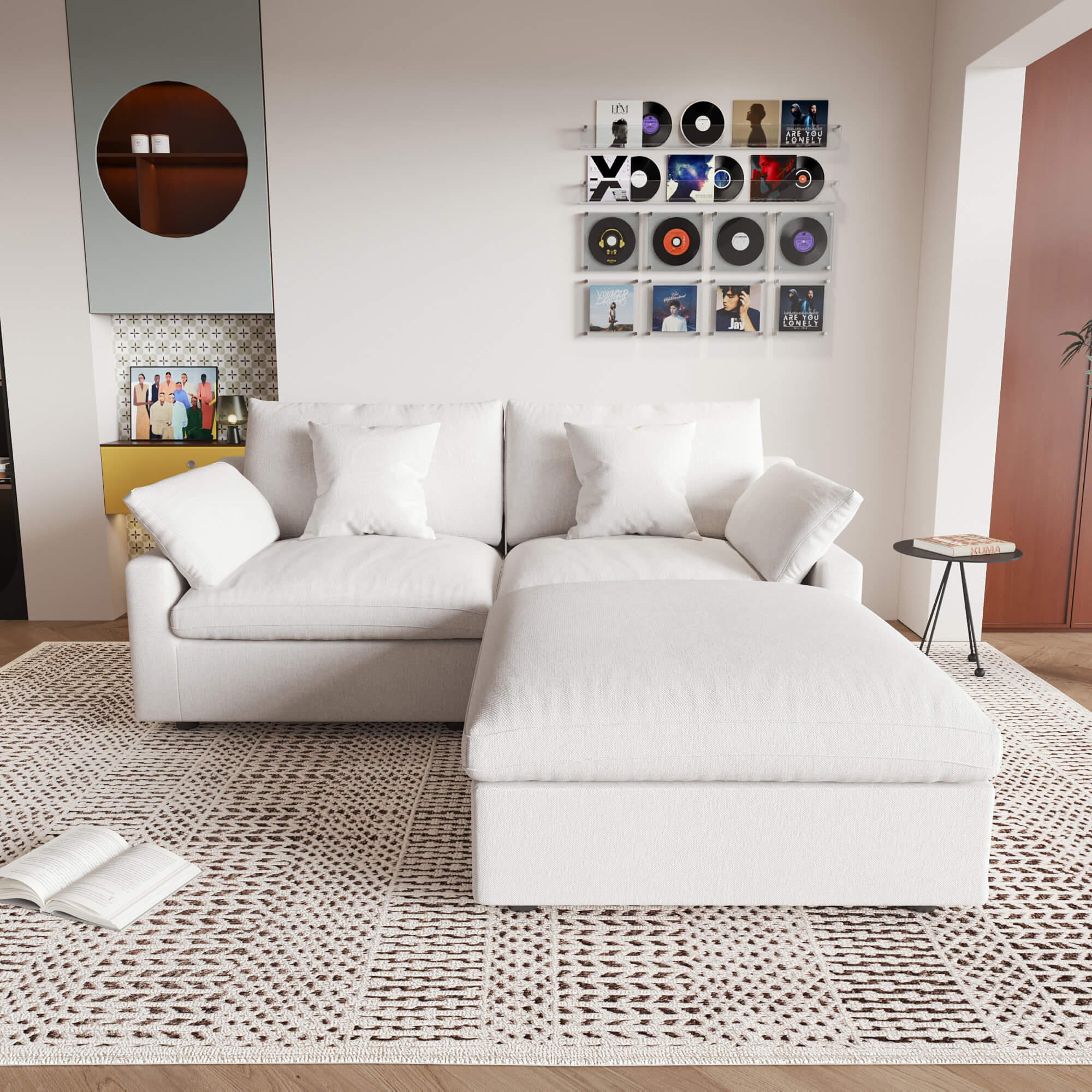 A white linen loveseat with ottoman, featuring a washable cloud design, placed on a patterned rug in a room with a record collection on the wall.