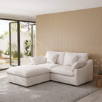 White sectional chaise lounge sofa in a modern living room with a striped wall and patio door.