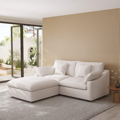 White sectional chaise lounge sofa in a modern living room with a striped wall and patio door.