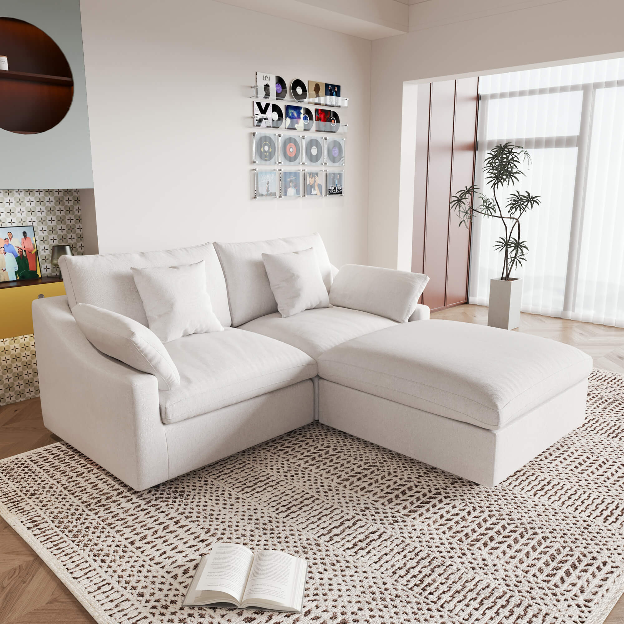 A white linen loveseat with ottoman, featuring a washable cloud design, placed on a patterned rug in a room with a record collection on the wall.