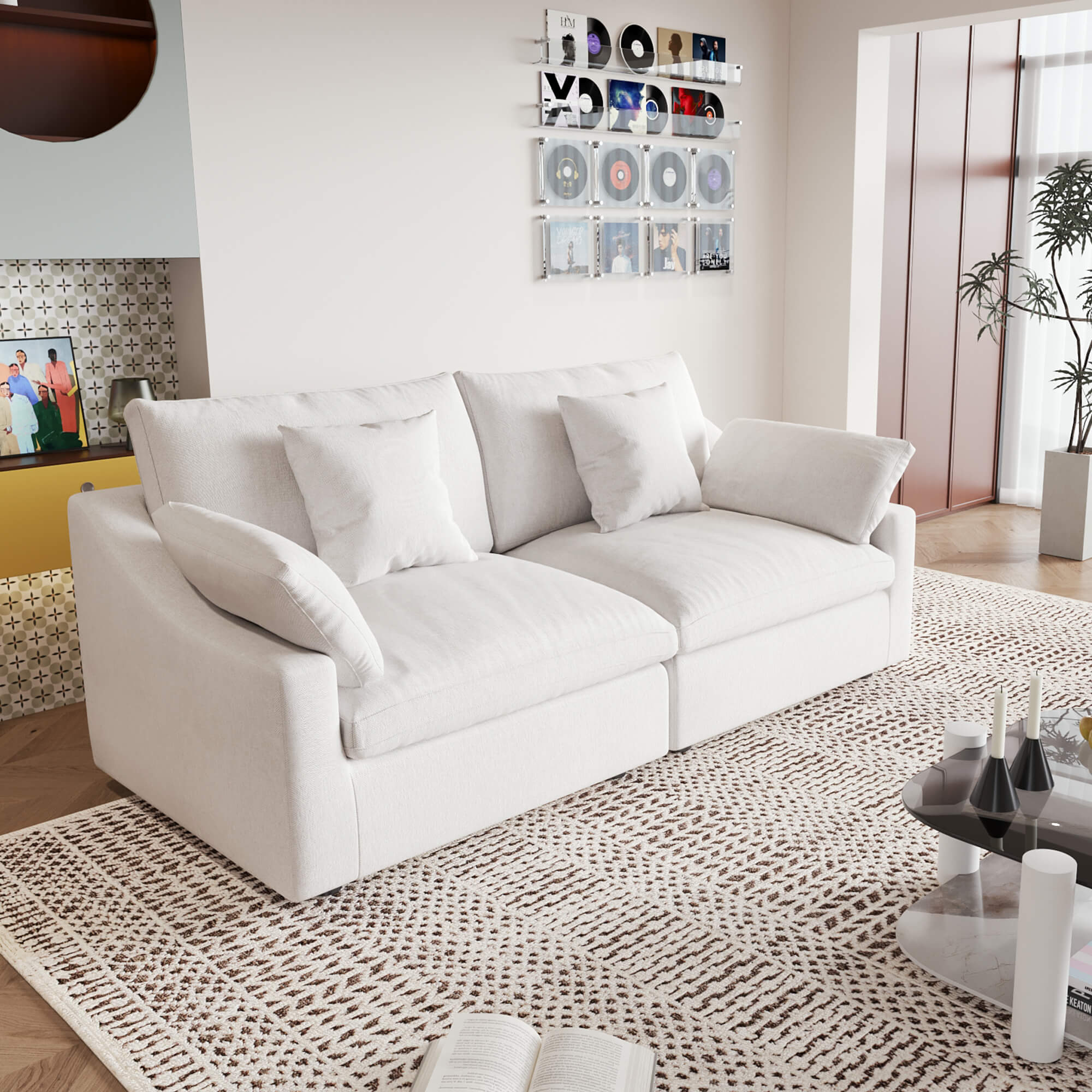A white loveseat sofa, featuring a minimalist design with removable cushions, placed in a room with modern decor.