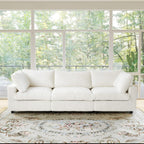 Beige 3-seat sofa in a room with large windows and a floral rug