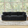 Black faux rabbit fur 3-seat sofa in a room with large windows and a decorative rug.