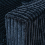 Close-up of a wide armrest of a black faux rabbit fur sofa