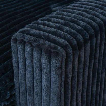 Close-up of a wide armrest of a black faux rabbit fur sofa