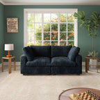 A black faux rabbit fur 2-seater sofa with removable covers, positioned in a room with green walls, a large window, and a wooden floor.