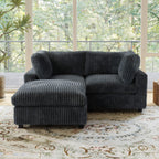 Black faux rabbit fur sectional loveseat sofa with ottoman in a room with large windows and a decorative rug.