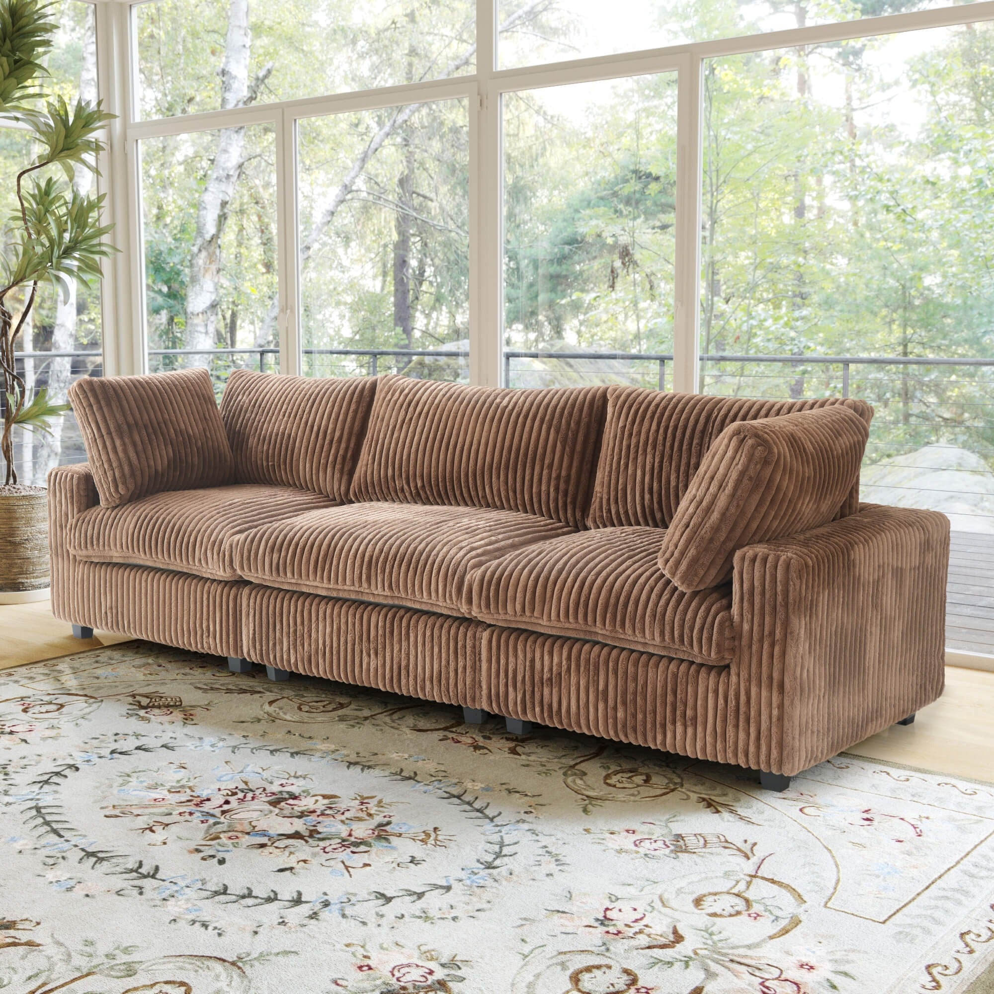 Brown faux rabbit fur 3-seat sofa in a room with large windows and a decorative rug.