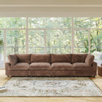 Brown faux rabbit fur 4-seat sectional sofa in a living room with large windows and a view of trees.