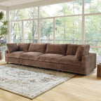 Brown faux rabbit fur 4-seat sofa in a living room with large windows and a rug.