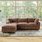 Brown L-shaped sectional sofa in a room with large windows and a view of trees.
