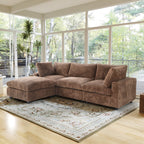 Brown L-shaped sectional sofa in a living room with large windows and a decorative rug.