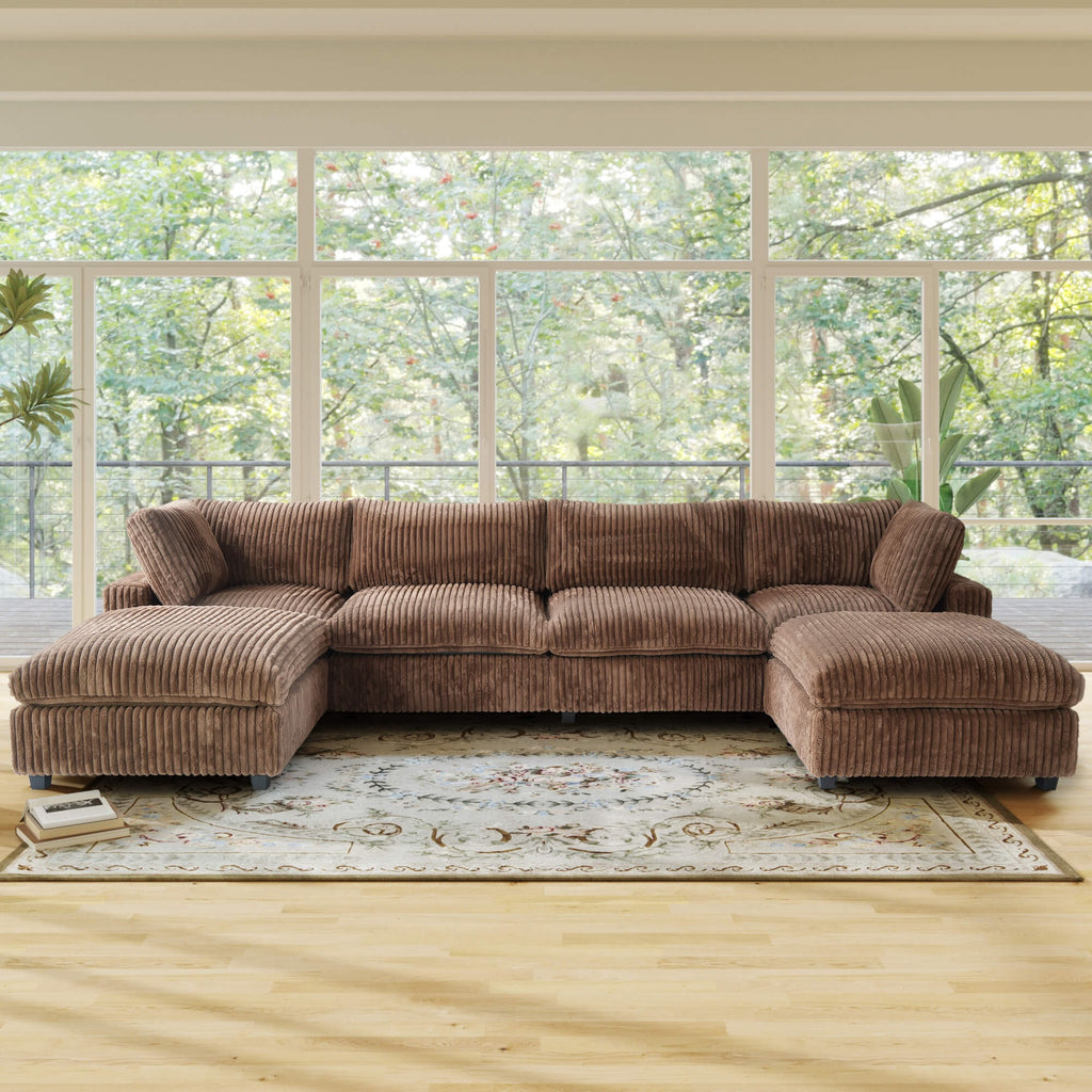 Brown U-shaped sectional sofa in a room with large windows and a rug.
