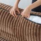 Person unzipping a cushion cover of a brown faux rabbit fur sofa