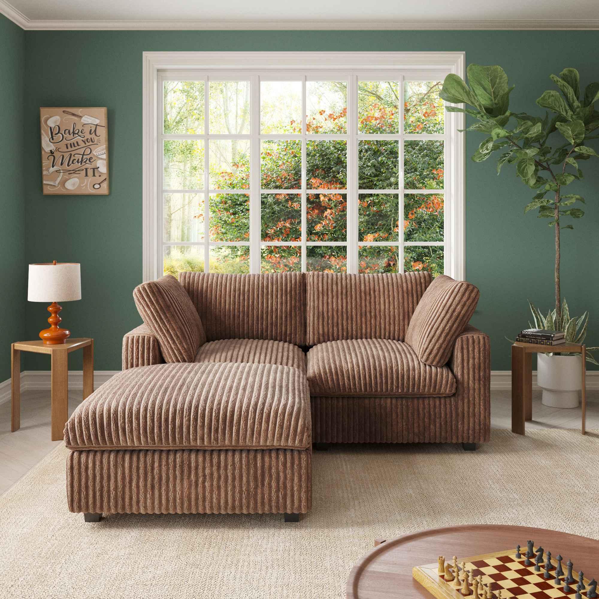 A brown faux rabbit fur loveseat and ottoman, placed in a room with green walls, a large window, and a striped pattern.