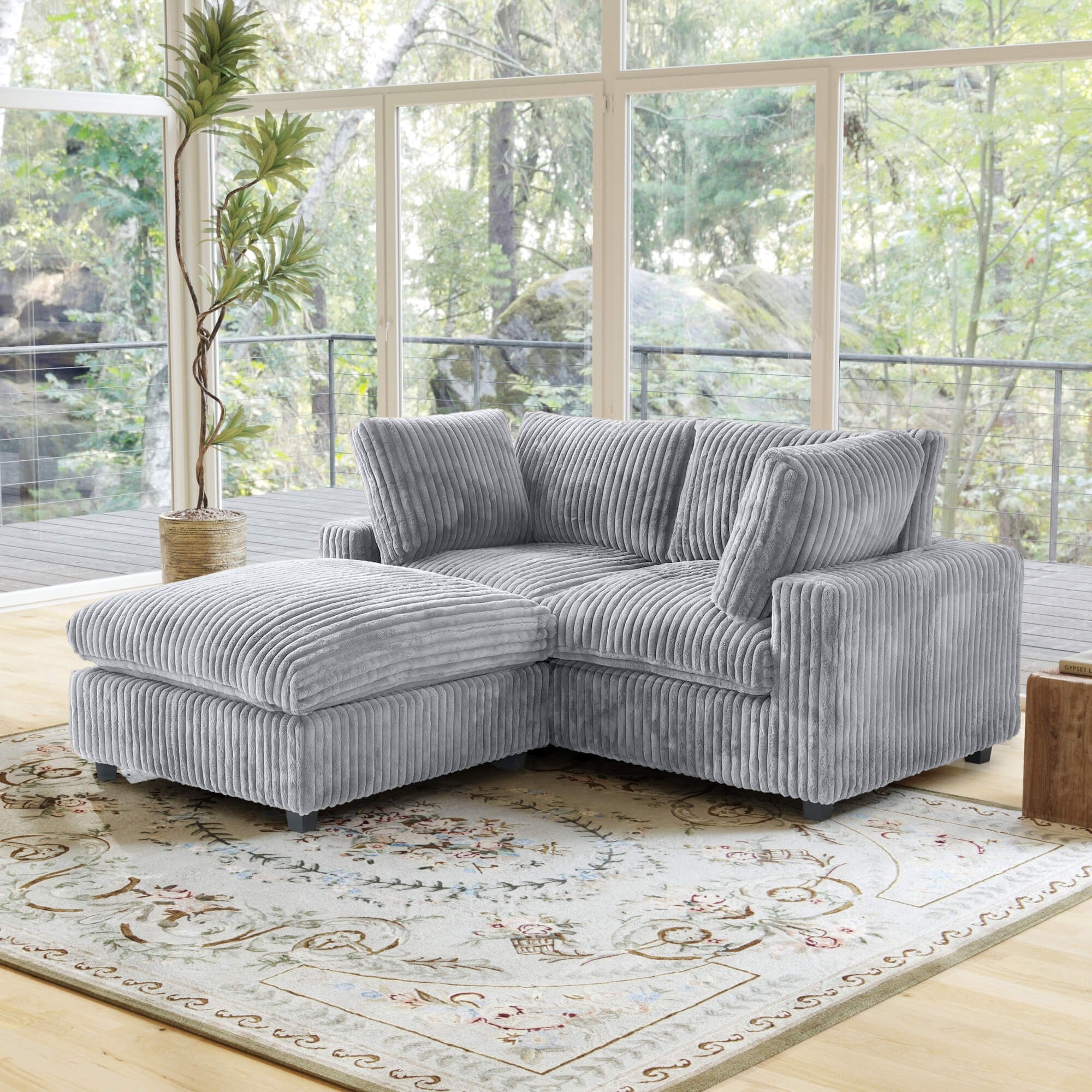 Gray fuzzy 2-seater sectional with ottoman and machine washable slipcovers.