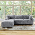 Gray L-shaped sectional sofa in a room with large windows and a rug.