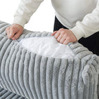 Person unzipping cushion cover of a light gray faux rabbit fur sofa