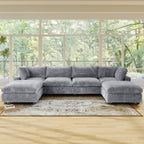 Gray U-shaped sectional sofa in a living room with large windows and a rug.