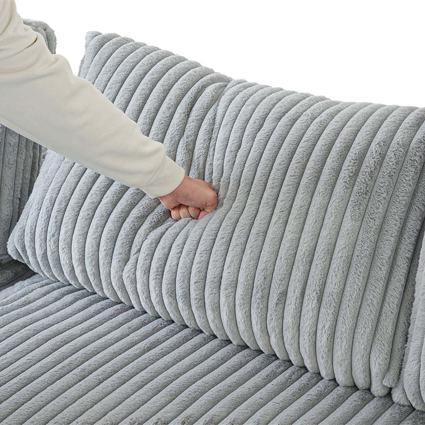 Gray textured sofa with a hand touching the surface