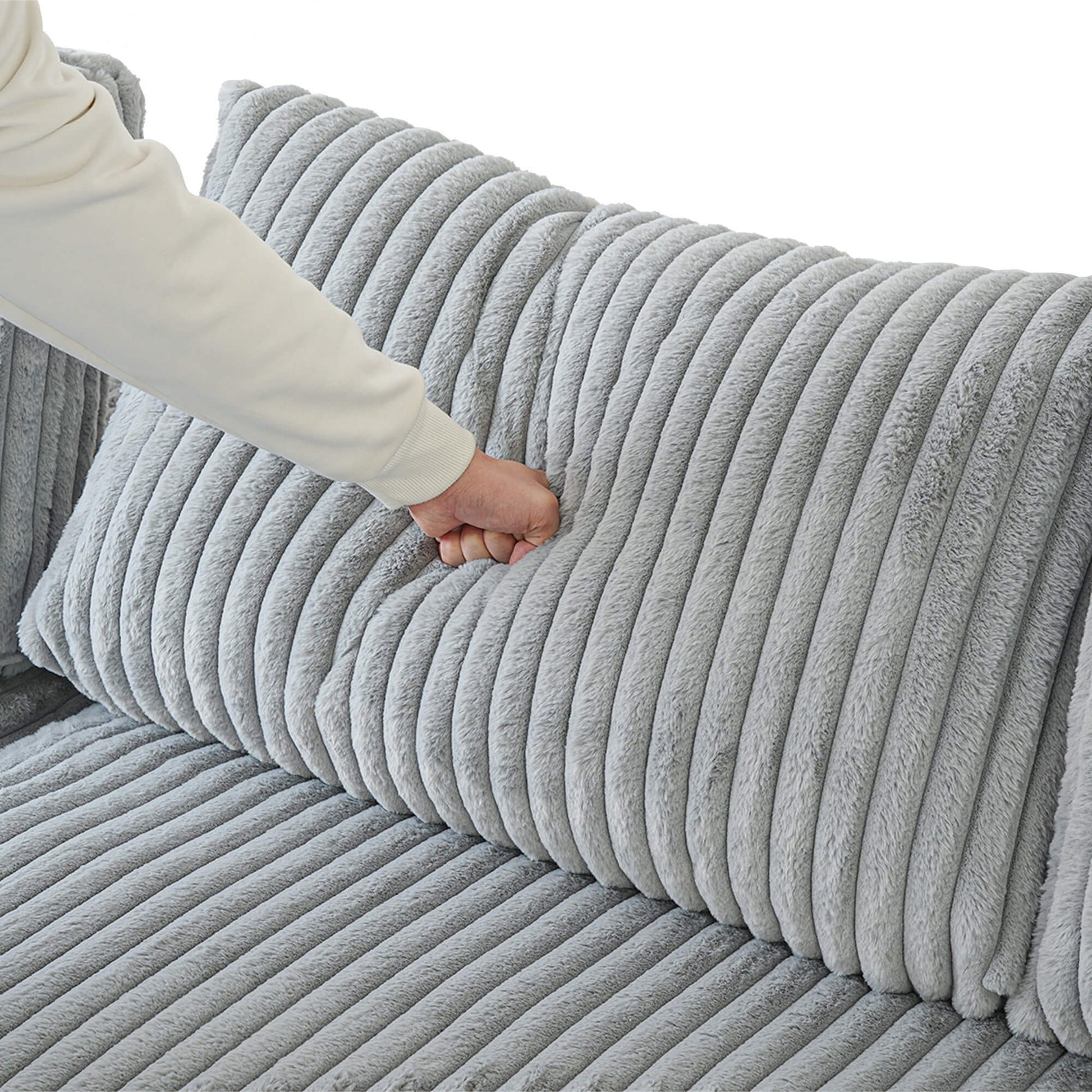 Gray textured sofa with a hand touching the surface
