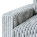 Close-up of a wide armrest of a faux rabbit fur sofa in light gray