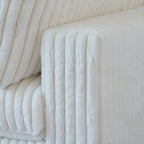 Close-up of a wide armrest of a white faux rabbit fur sofa