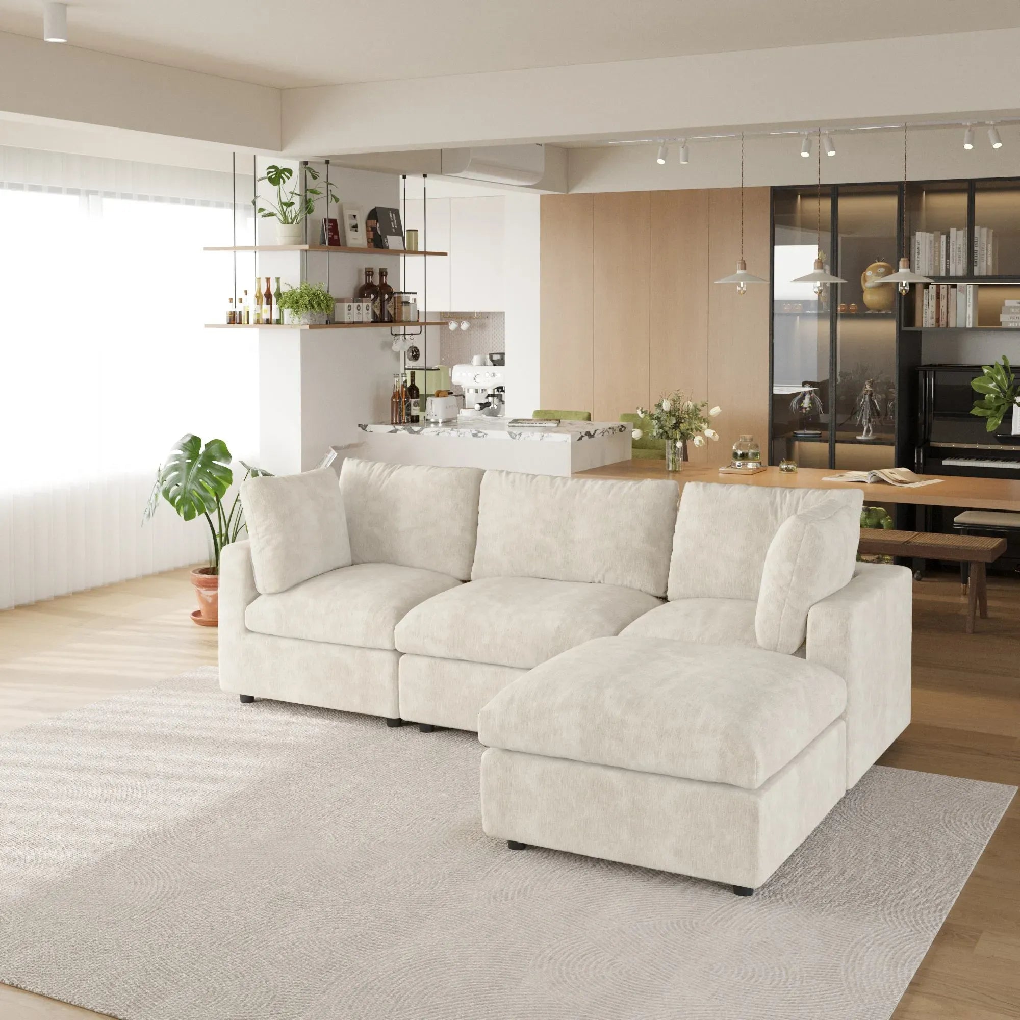 Beige L-shaped 4-seater sectional sofa in a modern living room with a kitchen in the background.