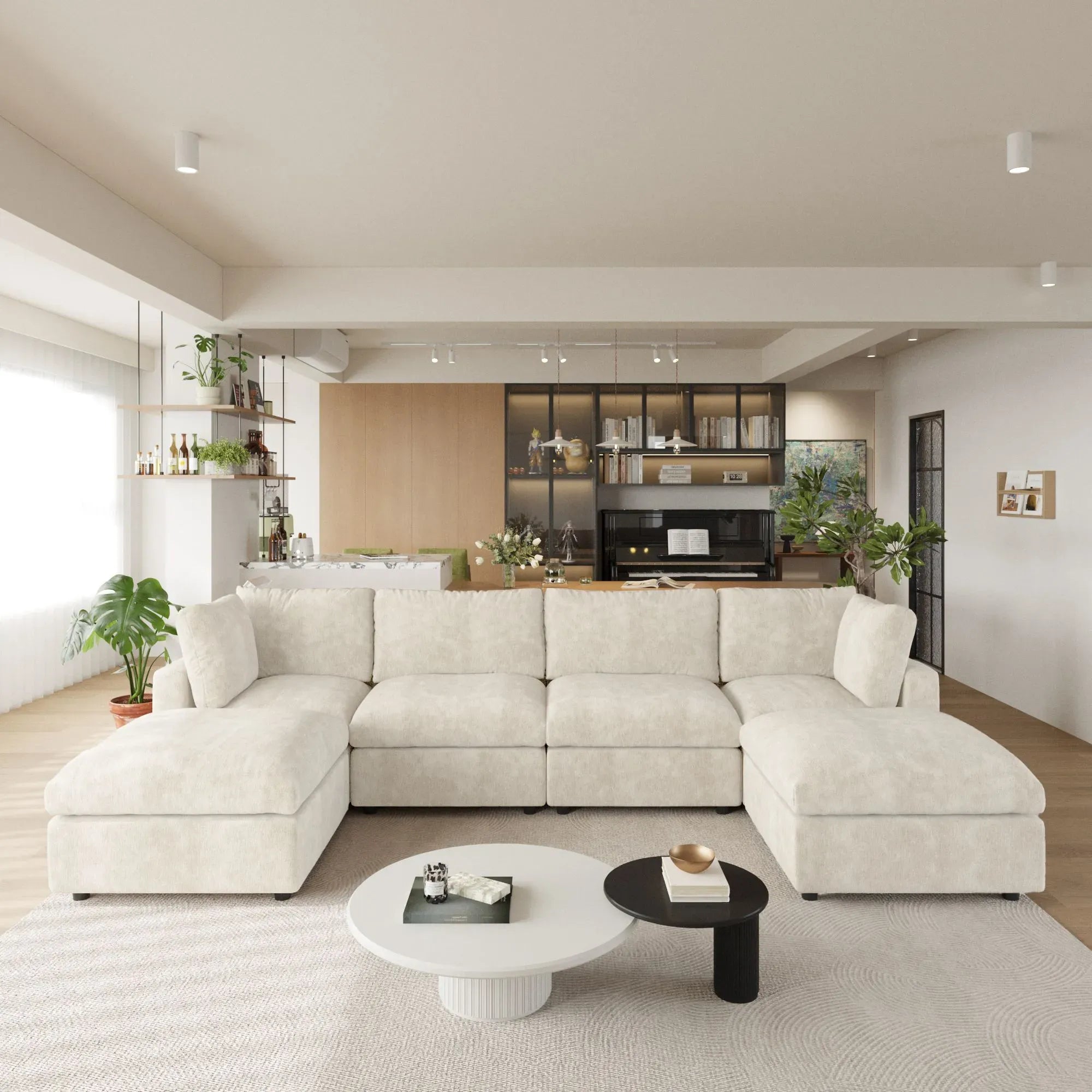 Modern living room with a beige U-shaped 6-seater sectional sofa, coffee table, and kitchen in the background.