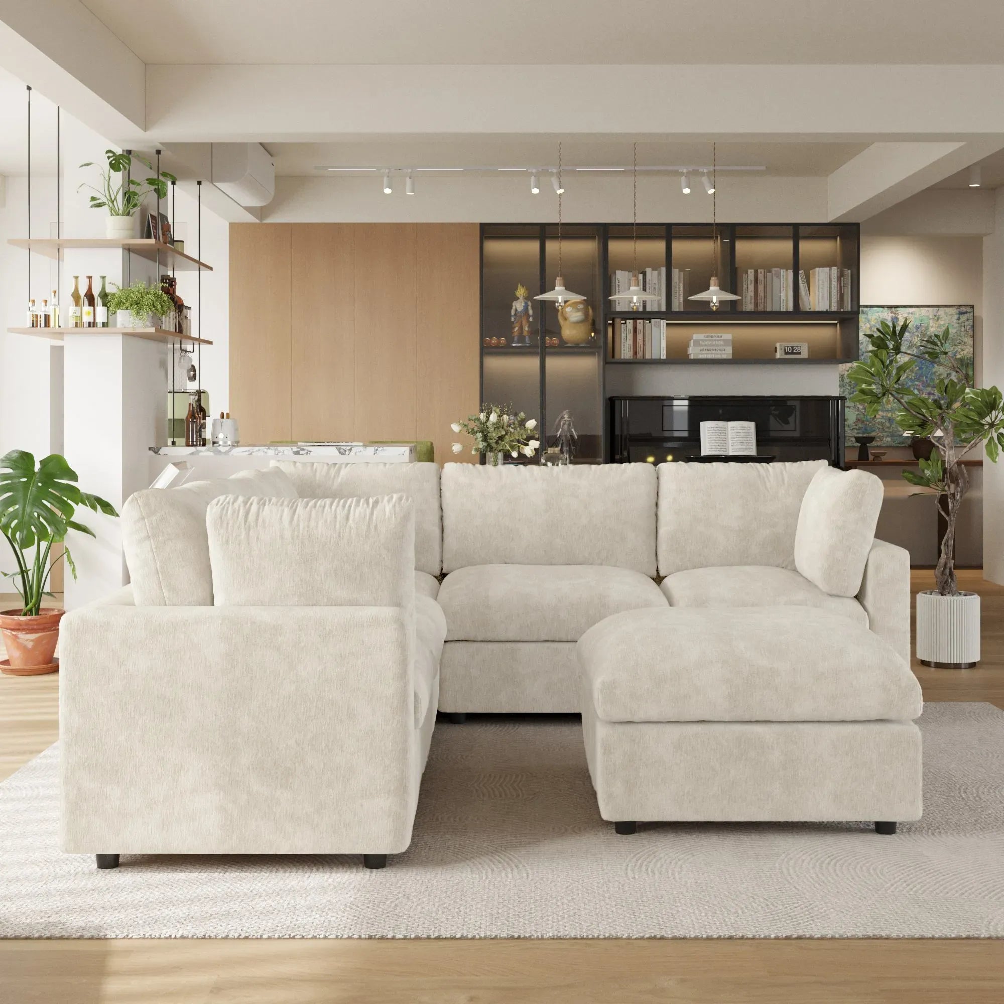 Beige V-shaped corner sectional sofa with ottoman in a living room with decor elements.
