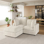 Beige sectional sofa in a modern living room with a kitchen in the background.