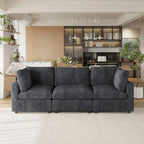 Black 3-seater sofa in a modern living room with a kitchen in the background
