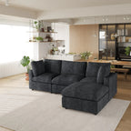 Black L-shaped 4-seater sectional sofa in a modern living room with a kitchen in the background.