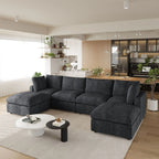 Modern living room with a black U-shaped 6-seater sectional sofa, coffee table, and decorative items.