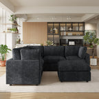 Black V-shaped corner sectional sofa with ottoman in a modern living room with decor elements.