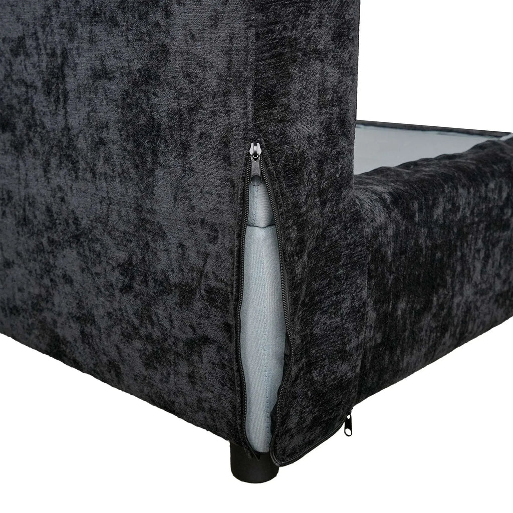 Black textured couch with a visible zipper on a white background