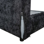 Black textured couch with a visible zipper on a white background