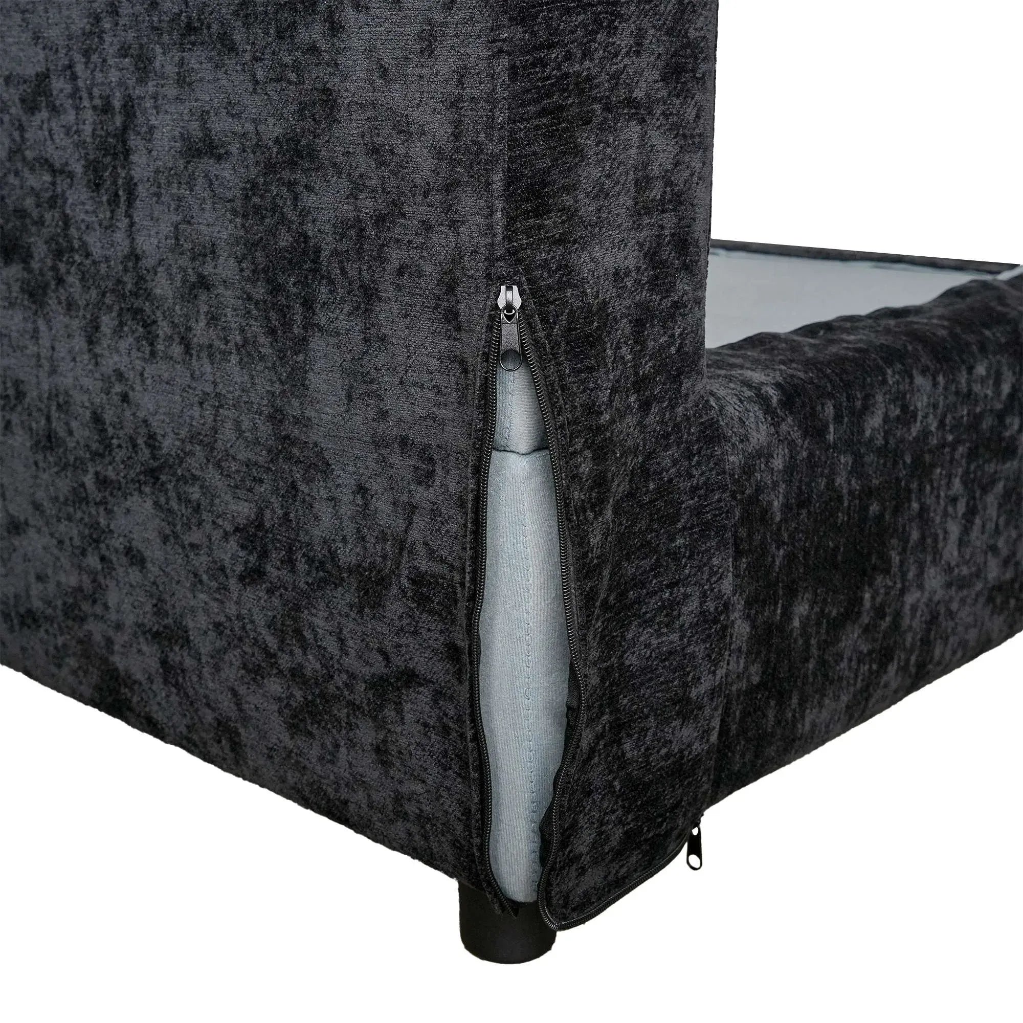 Black textured couch with a visible zipper on a white background