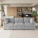 Gray sectional 3-seater sofa in a modern living room with bookshelves and decor.