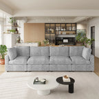 Gray 4-seater sectional sofa in a modern living room with coffee tables and decorative items.