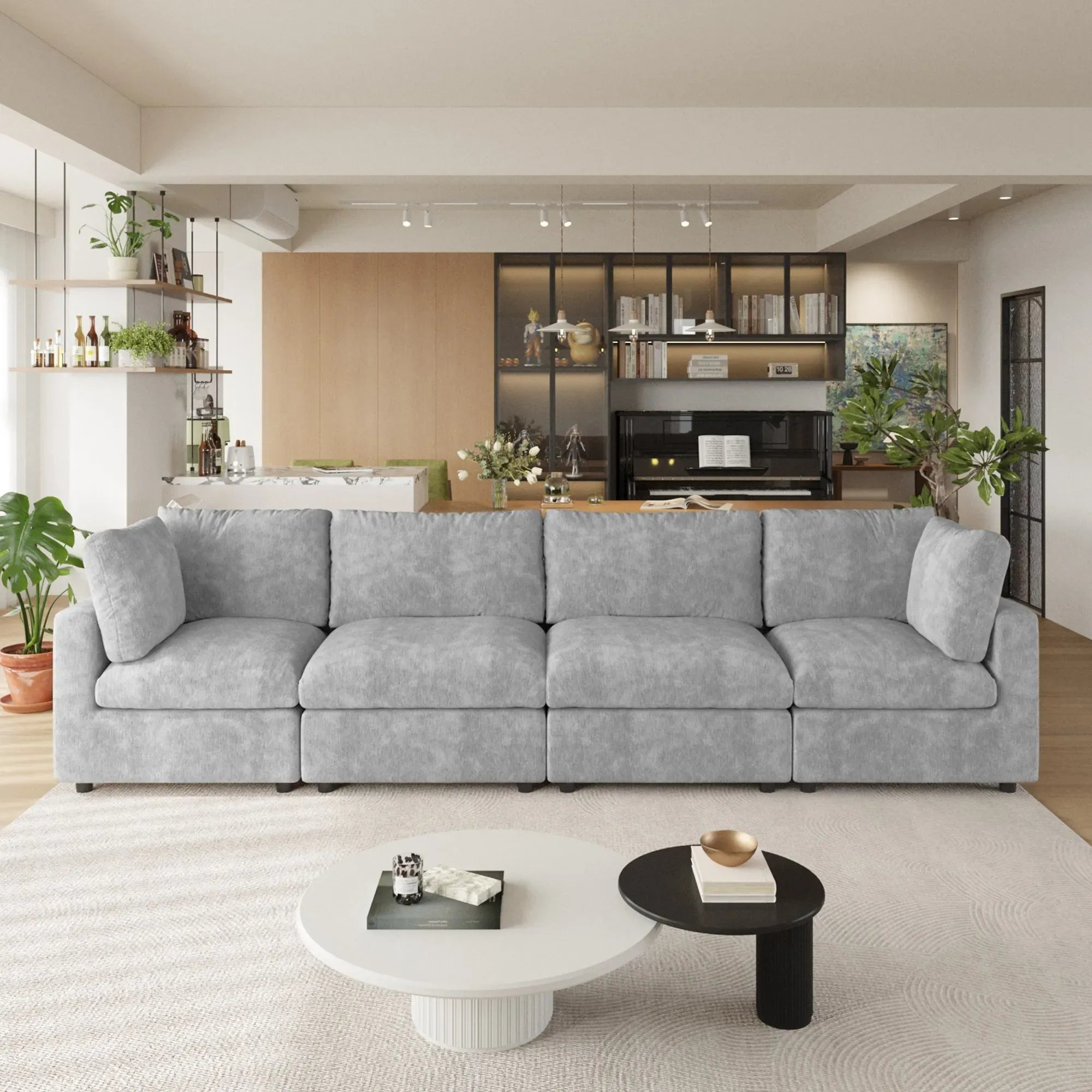 Gray 4-seater sectional sofa in a modern living room with coffee tables and decorative items.