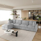 Gray L-shaped 5-seater sectional sofa in a modern living room with a kitchen in the background.