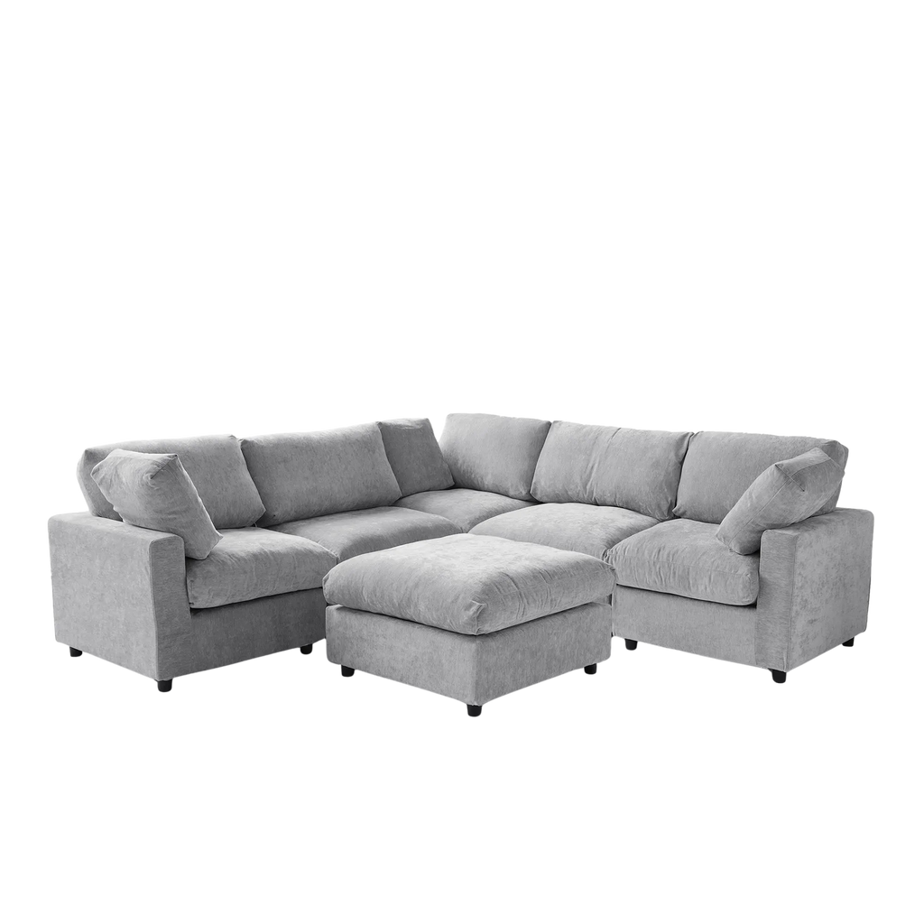 Gray V-shaped corner sectional sofa with ottoman on a white background