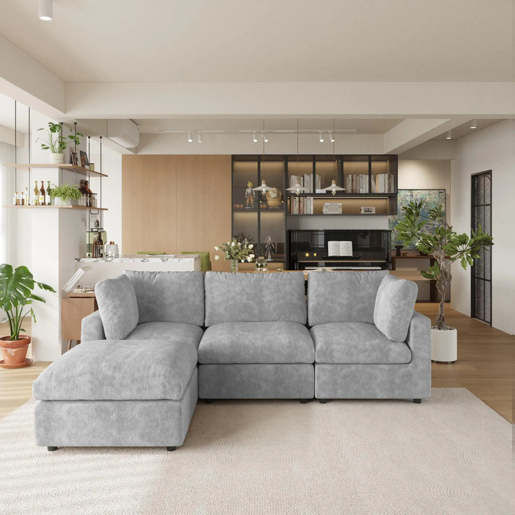 Gray L-shaped 4-seater sectional sofa in a modern living room with kitchen in the background