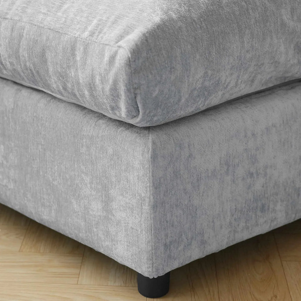 Gray upholstered sofa frame on a wooden floor