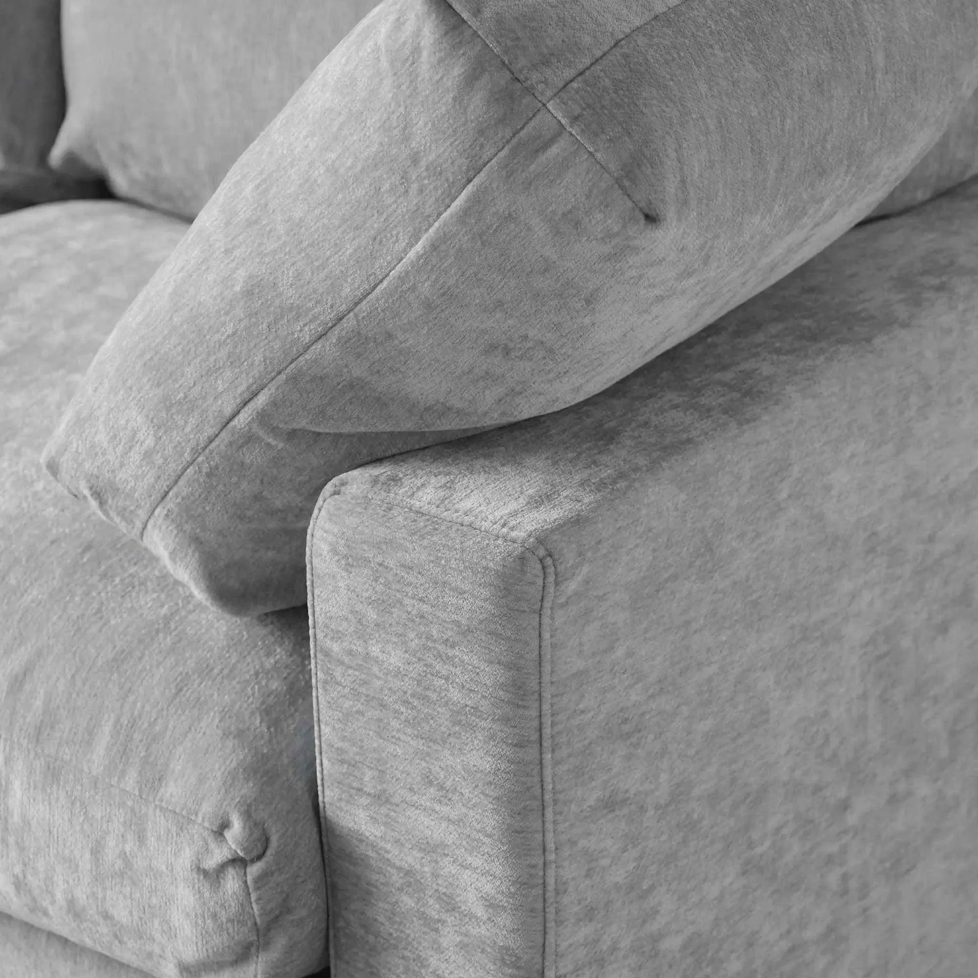 Gray fabric sofa with a close-up of the corner showing texture and stitching.
