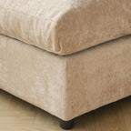 Close-up of a khaki upholstered sofa corner on a wooden floor